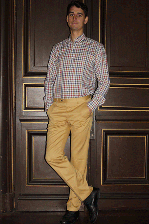 Jeune homme qui porte une chemise à col boutonné à carreaux vichy 100% coton sergé de couleur bleu, kaki, rouille et moutarde